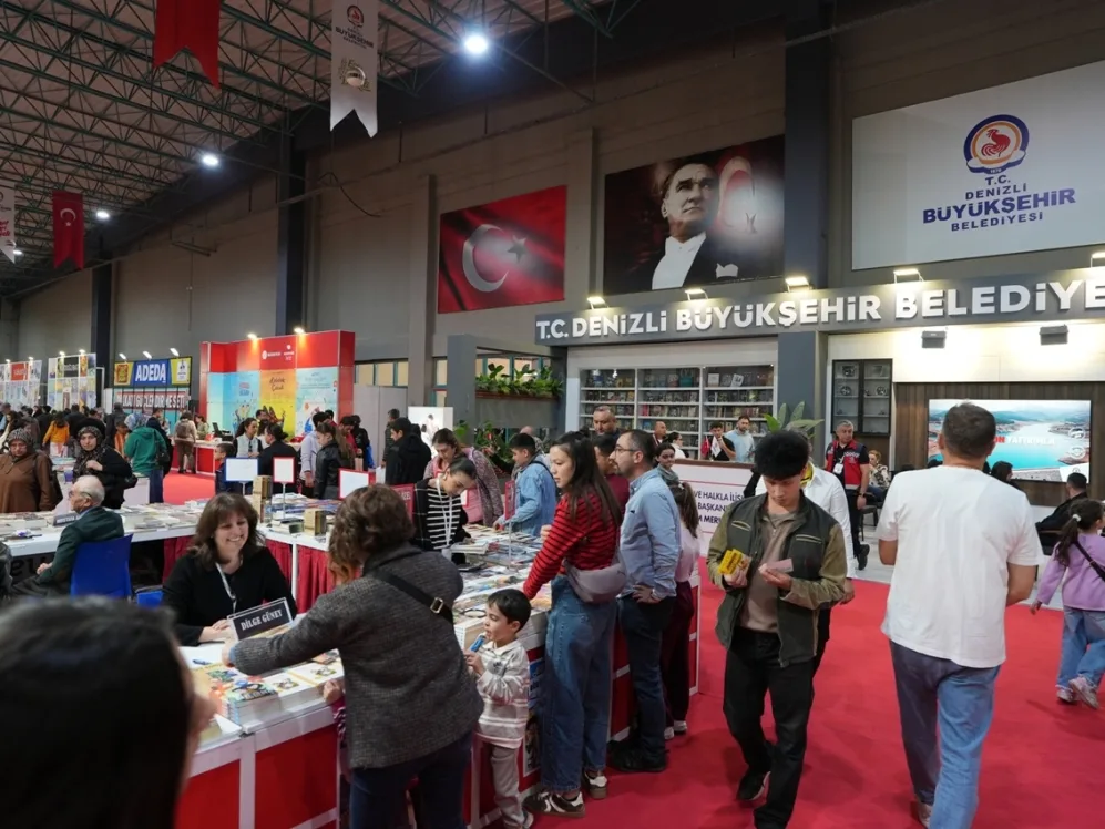 Denizli TUYAP Kitap Fuarinda standlari gezen ve kitap inceleyen kalabalik ziyaretciler gorunuyor.